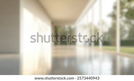 Blurred background of spacious interior featuring large windows that fill the room with natural light, creating an inviting atmosphere and linking to the serene greenery outside.