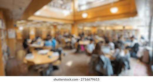 Blurred Background of Students Engaged in Study and Collaboration in a Modern Library Space Filled with Natural Light and Shelves of Books