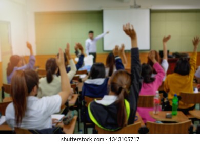Blurred background of students raising hands in the training room, business meeting and educational concept - Shutterstock ID 1343105717