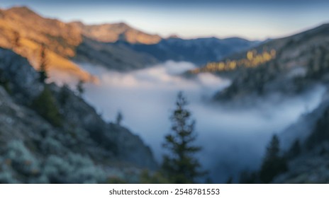 Blurred background of a stunning view of a misty mountain pass at dawn, with fog gently rolling through the valley. this serene landscape captures the beauty of nature in early morning light. - Powered by Shutterstock