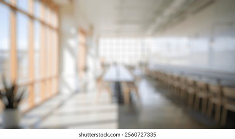 Blurred background of a stylish and airy dining area showcasing modern design with natural light, simple wooden tables, and lush greenery, creating a welcoming atmosphere for gatherings. - Powered by Shutterstock