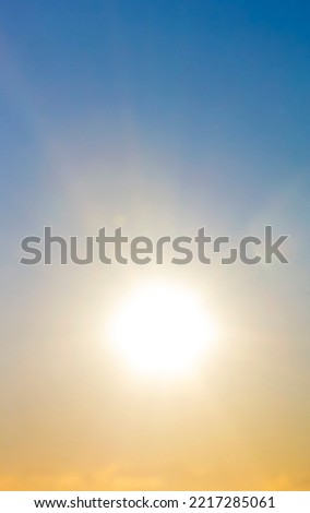 Blurred background. Sun in sky. Bright sun with sunbeams shines on clean yellow blue sky. Bright sun light, sun ray lens flares, sunshine day, sunny light, sunshiny boke. Beautiful natural background