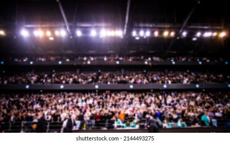 blurred background of supporters at sports event crowd of people in a basketball court