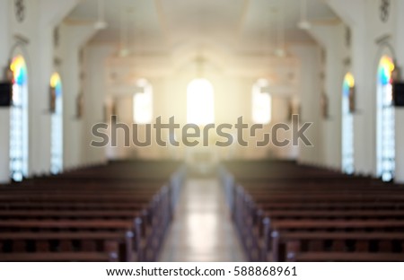 Blurred background of a surreal illuminated church aisle.
