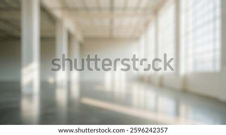 Blurred background of this image features an expansive industrial loft with ample natural light streaming through large windows, creating an ideal backdrop for creative projects or events.