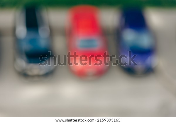 Blurred background of three\
cars. Blurred background of a city street defocused natural image.\
