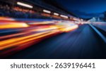 Blurred background of thrilling atmosphere of a motorsport raceway at night, highlighted by dynamic lighting and vibrant colors, capturing the essence of speed and excitement.