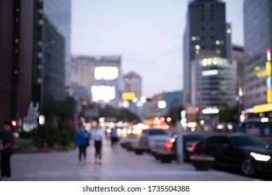 Blurred Background Of Traffic On The Road And People Walking On Sidewalk, Business Area In City At Night, Seoul Korea, Perspective