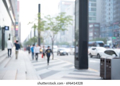 Blurred Background Of Traffic On The Road And People Walking On Sidewalk In City, Perspective.