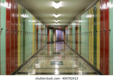 Blurred background of tunnel-like hallway lined with multi-colored lockers. - Shutterstock ID 404702413
