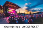 Blurred background of vibrant atmosphere of a summer concert held in an outdoor arena, featuring a lively audience cheering as the sun sets, creating a memorable experience.