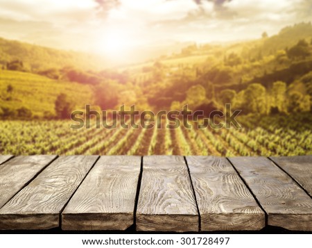 blurred background of vineyard and brown table 