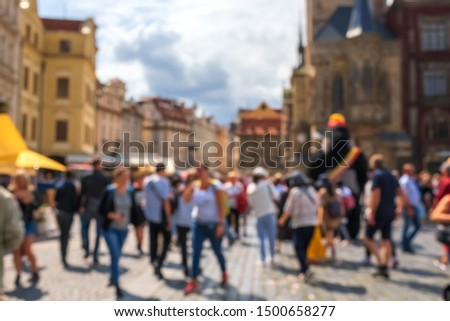 Blurred background with walking  people  on the street in old city.  Place for text.