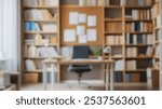 Blurred background of a well-organized home office setup featuring a desk against a backdrop of neatly arranged shelves, perfect for enhancing focus and productivity.