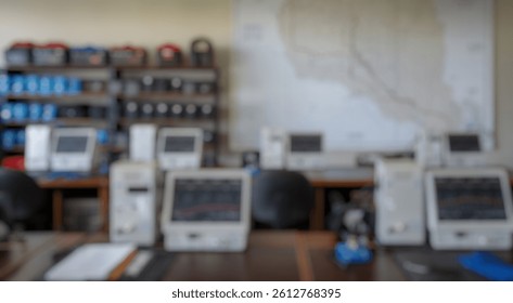 Blurred background of a well-organized laboratory workspace showcasing advanced scientific equipment including monitors and mapping tools, ideal for data analysis and research activities.