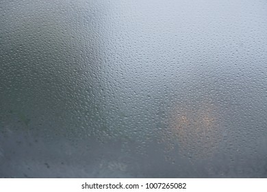 Blurred Background When See Through Car Windshield With Full Droplets