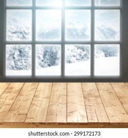 blurred background of winter window landscape and xmas table of empty space 