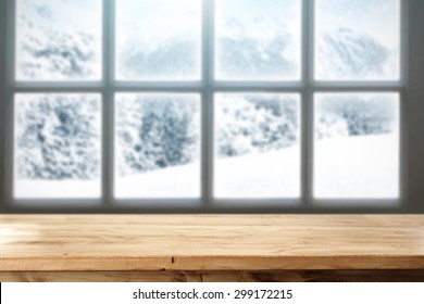 blurred background of winter window landscape and desk space of yellow colors 