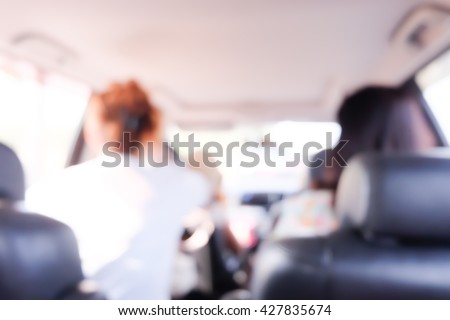 Blurred  background of women with friend in car.