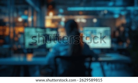 Blurred background of a young female programmer is deeply focused on her work, surrounded by multiple screens displaying code and data in a sleek modern office setting.