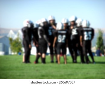 Blurred Background With Youth American Football Players In Action                              