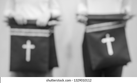 Blurred Black And White, Offering Fabric Bags With Cross In Church.