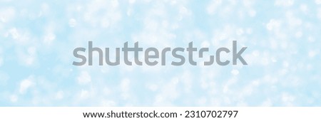 Blurred blue background. Beautiful bokeh texture with bright highlights. Winter holiday background is great for Christmas and New Year design.