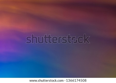 Blurred blue and orange abstract lens flare background. Defocused glow. Illuminated soft shine