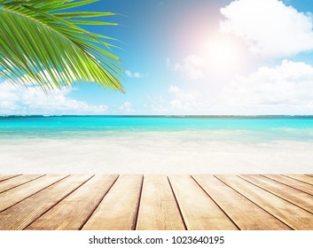 Blurred blue sky and sea with bokeh light and old wooden table background - Powered by Shutterstock