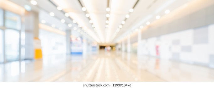 Blurred Bokeh Panoramic Banner Background Of Exhibition Hall Or Convention Center Hallway. Business Trade Show Event, Modern Interior Architecture, Or Commercial Tradeshow Conference Seminar Concept