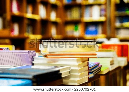 Blurred bookstore with books on tables and shelves. Education, school, study, reading fiction concept