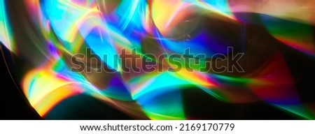 Blurred bright rainbow light. prism dynamic flare. Draving shiny spots. Dark background. Illuminated burst of multicolor light.