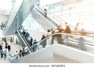 Blurred business people on a escalator, germany
