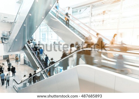 Blurred business people on a escalator, germany