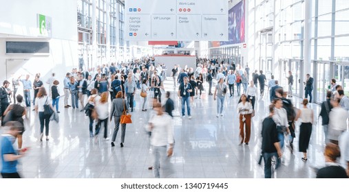 blurred business people at a trade fair - Shutterstock ID 1340719445