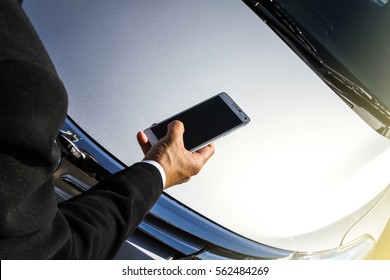 Blurred A Businessman Hand Holding A Smart Phone And Car