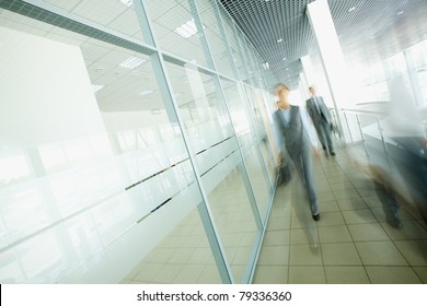 Blurred businesspeople moving in the corridor