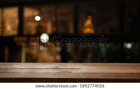 blurred cafe with empty wooden table for your product or montage