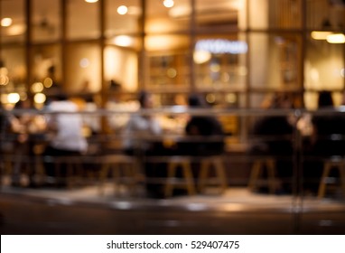 Blurred Of Cafe ( Restaurant ) With Light Gold In Night.For Modern Lifestyle Background.