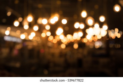 Blurred of cafe ( restaurant ) with light gold in night.For create abstract background.
