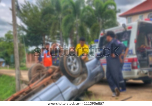 Blurred car accident. Car turned over after\
collision with the car. People suffered in the accident. Dangerous\
situation on the\
road.\
