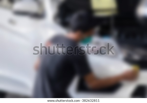 Blurred of car care\
staff cleaning the car.