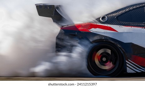 Blurred car drifting diffusion race drift car with lots of smoke from burning tires on speed track, Professional driver drifting car on race track with smoke. - Powered by Shutterstock