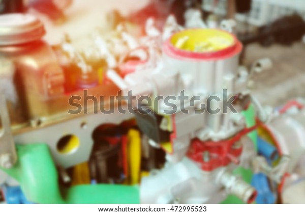 Blurred car engine part closeup of modern\
automobile motor car engine part, Blur image of checking car engine\
and Auto Repair and light. vintage\
color.