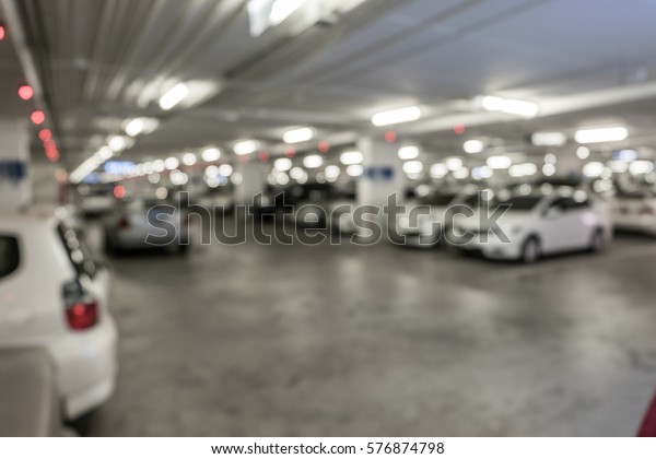 Blurred car park underground with a lot of cars,\
car park full.