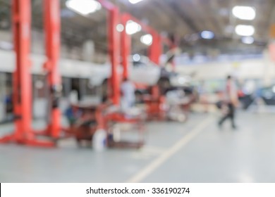 Blurred Of Car Technician Repairing The Car In Garage Background, Interior Of A Car Repair Station.