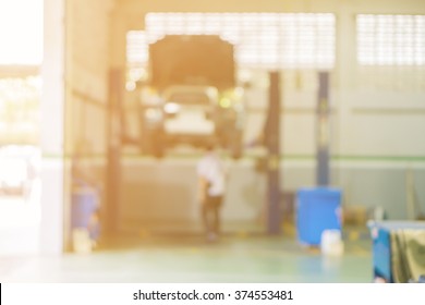 Blurred Of Car Technician Repairing The Car In Garage Background, Interior Of A Car Repair Station,Cars Servicing At Service Station,car Mechanic Work At Repair Service Station Garage,vintage Color.