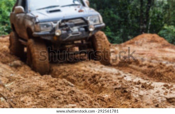 blurred car tires in dirt\
road