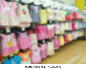 Blurred childrens undershirts on clothes hangers at a store.
