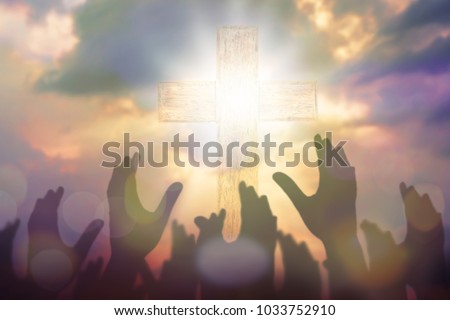 Blurred of Christian Congregation hands Worship God together in front of wooden cross in cloudy sky, conceptual image of praise and worship